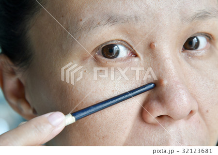 asian woman point mole on her face and nose asian woman point mole on her face and nose 32123681
