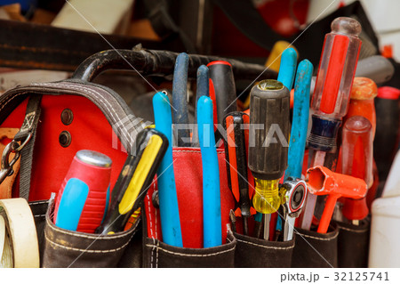 Work tools in bag on wood background. 32125741