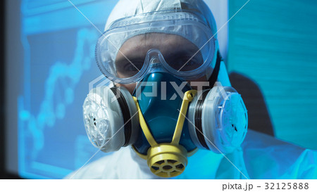 Person wearing a biohazard suit and mask Person wearing a biohazard suit and mask 32125888
