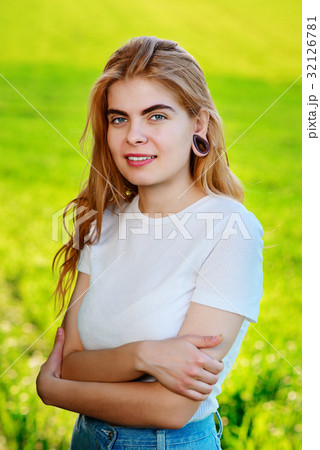 beautiful woman with wooden tunnels in her ears 32126781