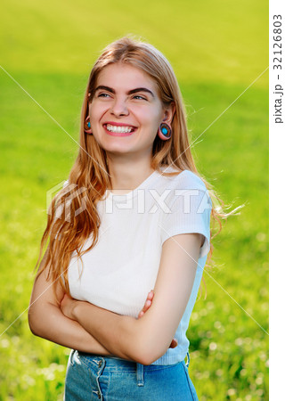 beautiful woman with wooden tunnels in her ears 32126803