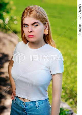 beautiful woman with wooden tunnels in her ears 32126804