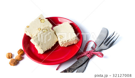 Hazelnut halva slices on a plate Hazelnut halva slices on a plate 32127008