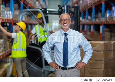 Warehouse manager standing with hands on hips 32128584