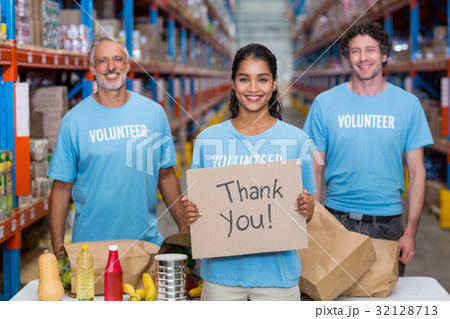 Happy colleagues holding sign boards with thank you message 32128713