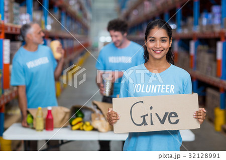 Portrait of happy volunteer holding sign boards with message Portrait of happy volunteer holding sign boards with message 32128991