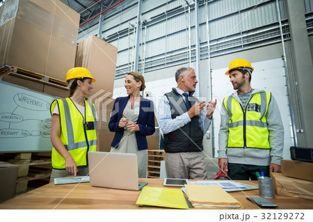 Warehouse workers and managers interacting with each other 32129272