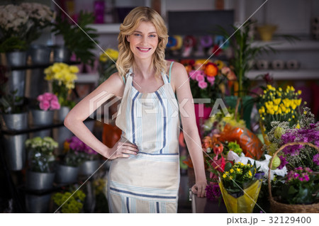 Happy female florist standing in flower shop 32129400