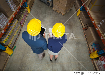 Warehouse manager and client standing 32129578