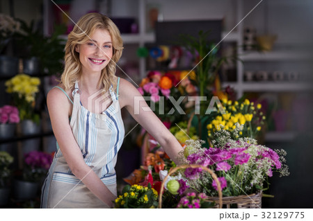 Happy female florist standing in flower shop 32129775