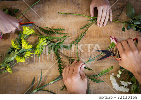 Hands of florist preparing flower bouquet Hands of florist preparing flower bouquet 32130168