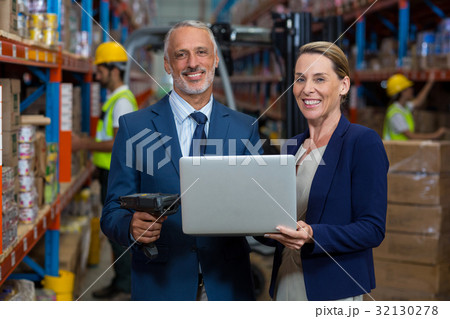 Warehouse manager and client using laptop Warehouse manager and client using laptop 32130278