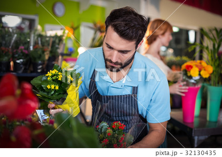 Male florist arranging flower bouquet 32130435