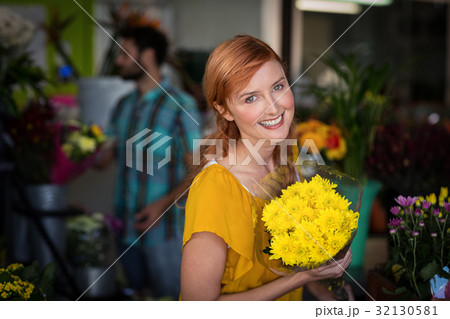 Portrait of female florist holding bouquet of flower 32130581