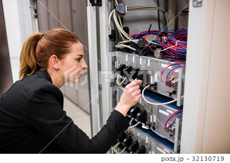 Technician examining server 32130719