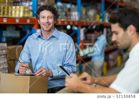 Two warehouse workers working together 32130858