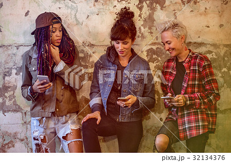 Group of girlfriends connected by mobile phone network 32134376