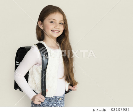 Young freckled girl carrying a backpack smiling portrait Young freckled girl carrying a backpack smiling portrait 32137982