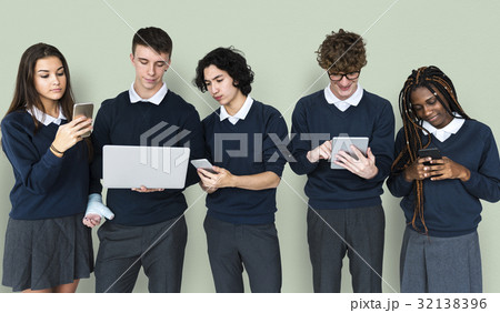 Diverse Group Of Students Using Electronic Devices 32138396