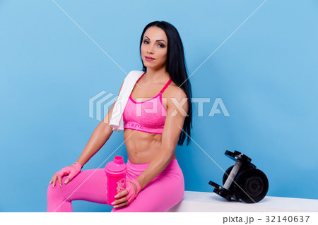 Muscular woman have a rest and holding shaker Muscular woman have a rest and holding shaker 32140637