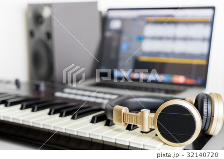 Home Music computer studio with golden headphone 32140720