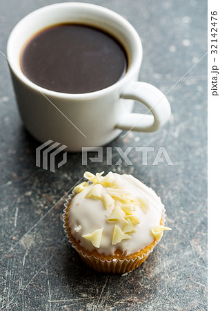 Tasty cupcake and coffee cup. 32142476