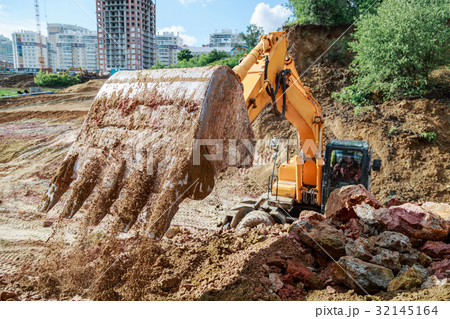 Excavator performs excavation work 32145164