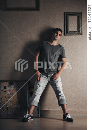 Male model, standing in a dark interior 32145526