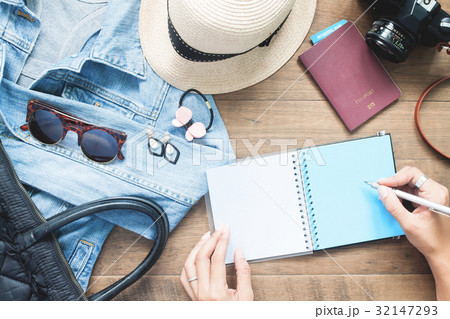 Creative flat lay of woman hands planning trip  32147293