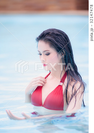 asia sexy woman standing in water at swimming pool 32147478