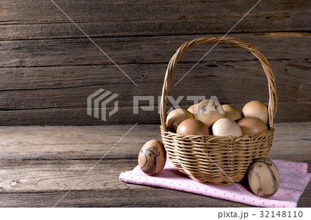 eggs in a wicker basket on wooden table 32148110