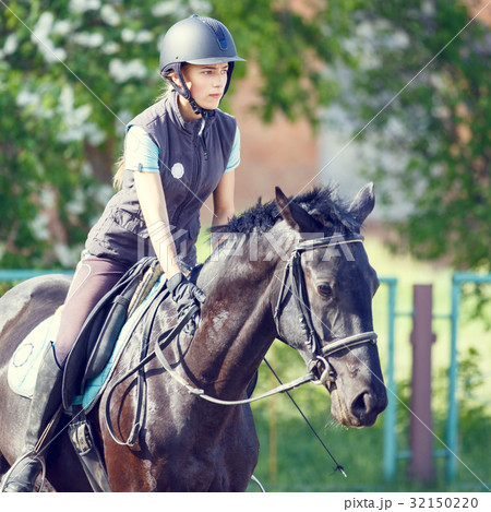 Young rider girl on horse at dressage competition Young rider girl on horse at dressage competition 32150220
