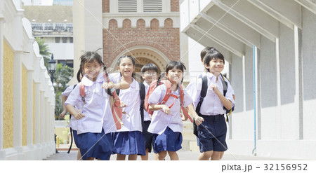 Students are smiling and running energetically on their way to school Students are smiling and running energetically on their way to school 32156952