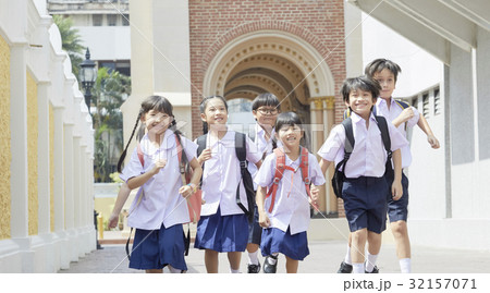 A portrait of pupils running happily outside. 32157071