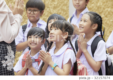 A photo of primary pupils smiling and greeting their teacher. 32157074