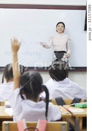 The Thai teacher is teaching English in classroom. 32157086