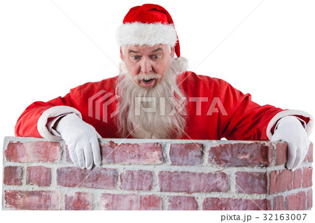 Santa claus peeking over the wall Santa claus peeking over the wall 32163007