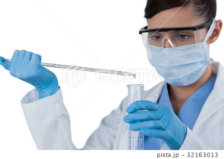 Female scientist conducting an experiment Female scientist conducting an experiment 32163013