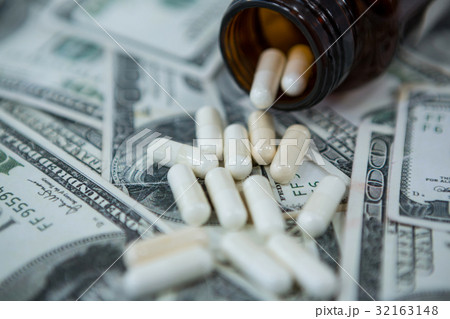 Pills spilling on currency notes Pills spilling on currency notes 32163148