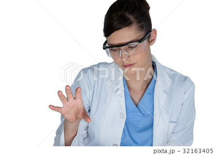 Beautiful female scientist using digital screen Beautiful female scientist using digital screen 32163405