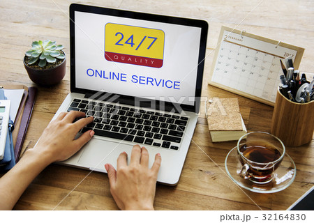 Hands holding digital device with 24/7 service 32164830