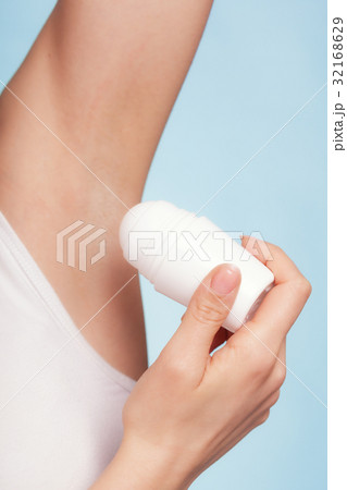 Girl applying stick deodorant in armpit. Skin care 32168629
