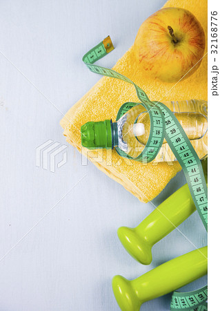 Dumbbells, an apple, a towel and a bottle of water Dumbbells, an apple, a towel and a bottle of water 32168776
