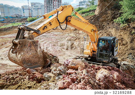 Excavator pours soil Excavator pours soil 32169288