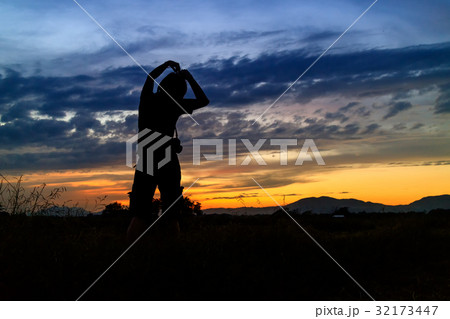 silhouette of woman and beautiful twilight with sunset silhouette of woman and beautiful twilight with sunset 32173447