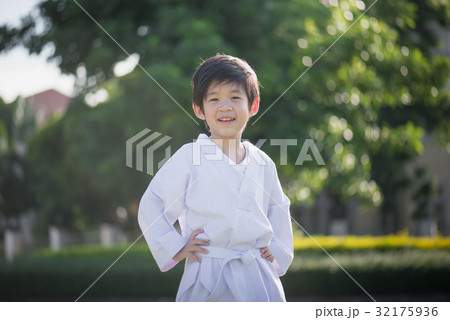 Asian child in white kimono during training karate 32175936
