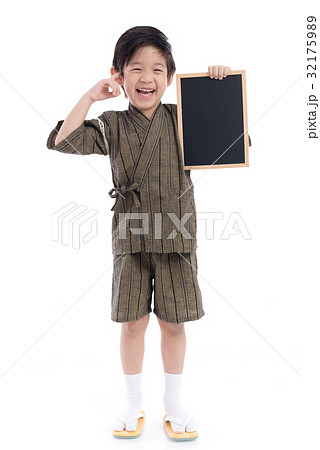 Cute asian boy in kimono holding black board Cute asian boy in kimono holding black board 32175989