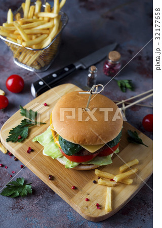 Hamburger with french fries, beer on a stone table Hamburger with french fries, beer on a stone table 32177658