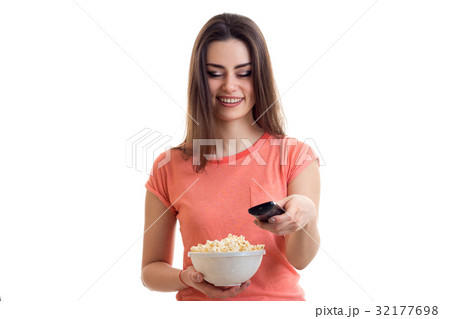 charming lady with pop corn in hand smiling and 32177698