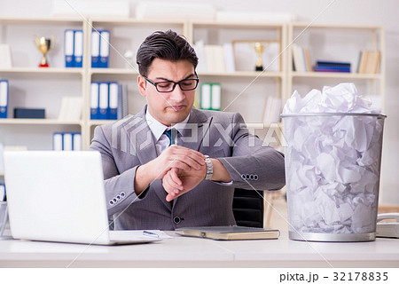 Businessman in paper recycling concept in office Businessman in paper recycling concept in office 32178835